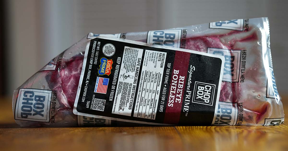 Chop Box ribeye steak on wooden surface