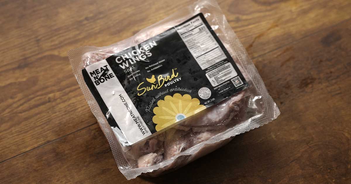 Meat N' Bone – Packaged chicken wings on wooden surface